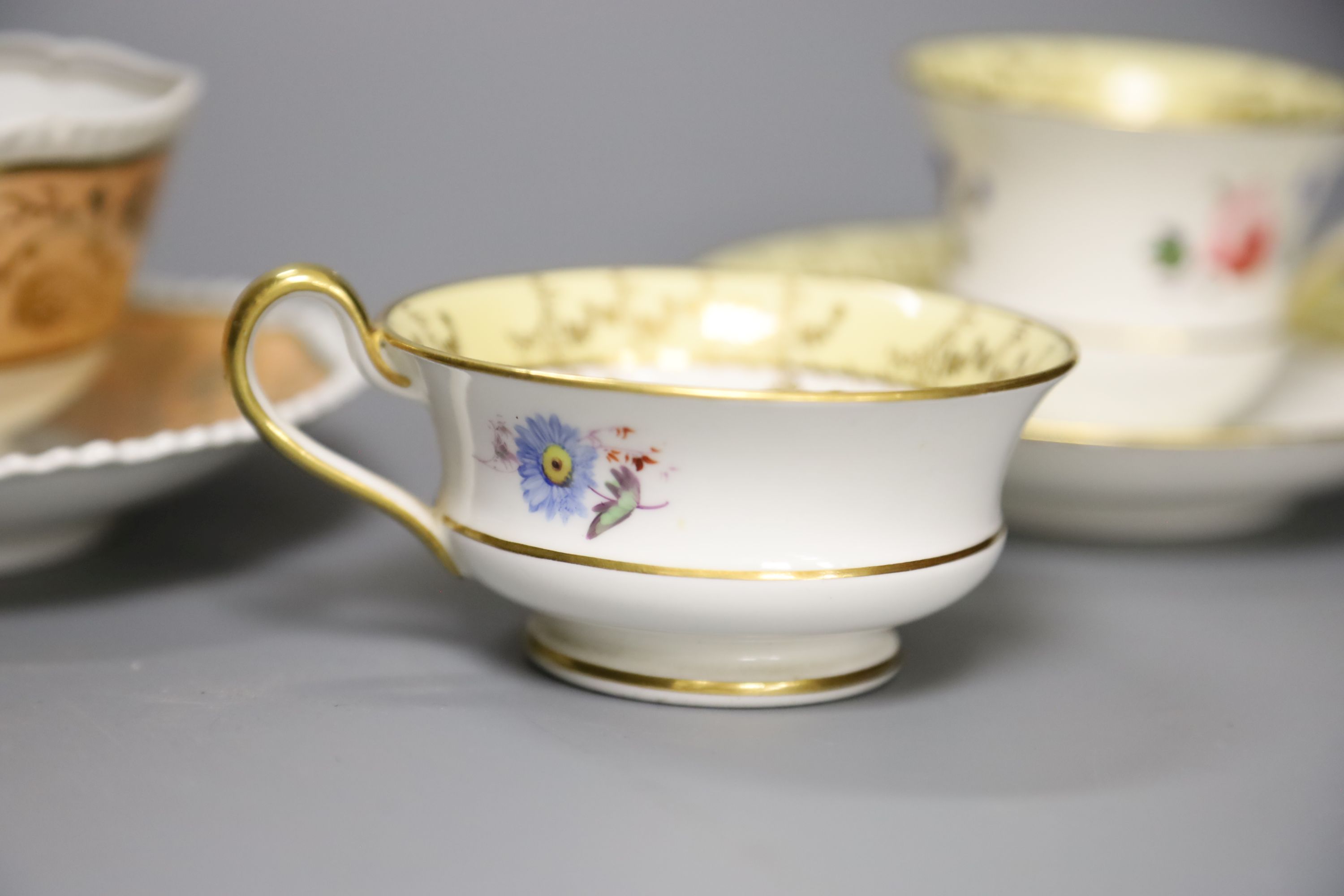 A Worcester Flight Barr teacup and saucer with gadroon border gilded with trailing berries on a salmon ground and Graingers Worcester